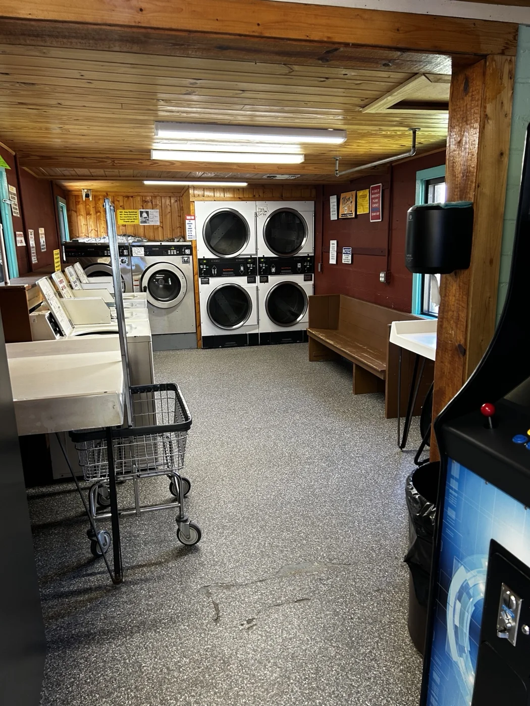 Laundry carts and washers leading toward the dryers
